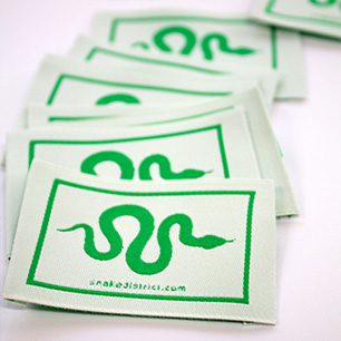 Premium Logo Label in green and white by Nominette
